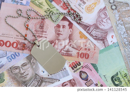 Thai baht currency money bills and military token. The concept of army service 141128545