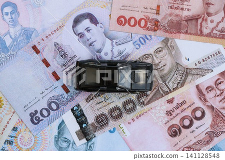 Thai baht currency money bills and toy car. The concept of car ownership Thai baht currency money bills and toy car. The concept of car ownership 141128548