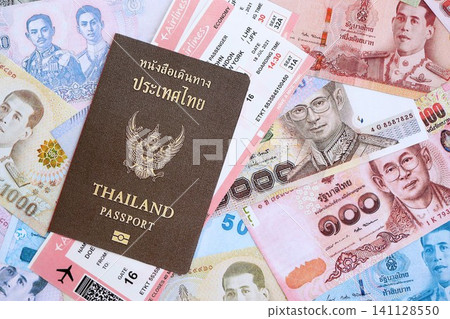 Thai baht currency money bills with tickets and passport. The concept of travel and vacation Thai baht currency money bills with tickets and passport. The concept of travel and vacation 141128550