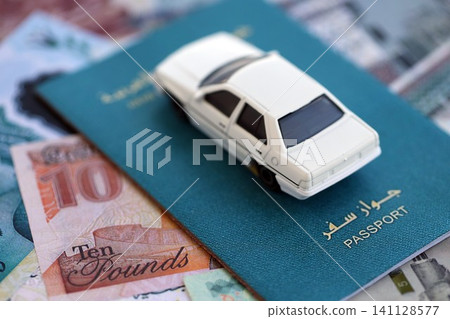 Egyptian pound currency money bills and car with passport. The concept of car ownership Egyptian pound currency money bills and car with passport. The concept of car ownership 141128577