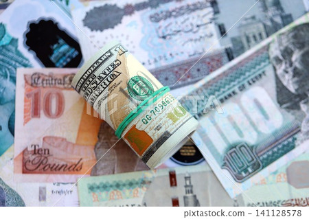 Egyptian pound currency money bills and bunch of us dollars. The concept of currency exchange Egyptian pound currency money bills and bunch of us dollars. The concept of currency exchange 141128578