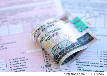 Egyptian pound money bills on tax form. Taxation and accounting concept Egyptian pound money bills on tax form. Taxation and accounting concept 141128587