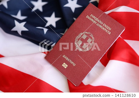 Greece passport on big waving flag of United States of America. US Visa and immigration Greece passport on big waving flag of United States of America. US Visa and immigration 141128610