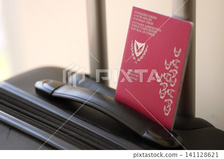 Kyprus passport on touristic baggage luggage in airport. Travel and tourism in Europe concept Kyprus passport on touristic baggage luggage in airport. Travel and tourism in Europe concept 141128621
