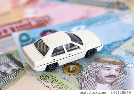 Bahraini dinar currency money bills and toy car. The concept of car ownership 141128679