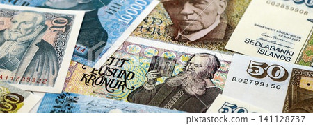 Icelandic krona money bills pile on table. Iceland banknotes of ISK currency close up Icelandic krona money bills pile on table. Iceland banknotes of ISK currency close up 141128737