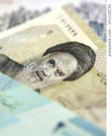 Iranian rial money bills pile on table. Iran banknotes of IRR currency close up. Concept of business Iranian rial money bills pile on table. Iran banknotes of IRR currency close up. Concept of business 141128739