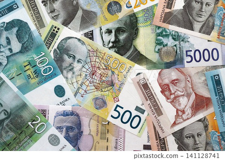 Serbian dinar money bills pile on table. Serbia banknotes of RSD currency. Concept of business Serbian dinar money bills pile on table. Serbia banknotes of RSD currency. Concept of business 141128741