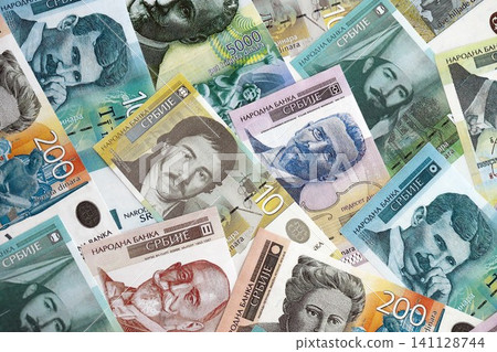 Serbian dinar money bills pile on table. Serbia banknotes of RSD currency. Concept of business Serbian dinar money bills pile on table. Serbia banknotes of RSD currency. Concept of business 141128744
