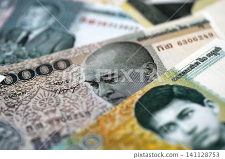 Cambodian riel money bills pile on table. Cambodia banknotes of KHR currency close up Cambodian riel money bills pile on table. Cambodia banknotes of KHR currency close up 141128753