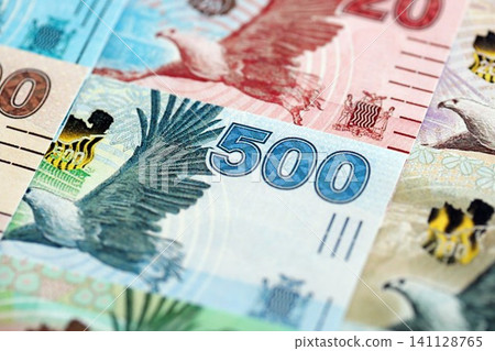 Zambian kwacha money bills pile on table. Zambia banknotes of ZMW currency close up Zambian kwacha money bills pile on table. Zambia banknotes of ZMW currency close up 141128765
