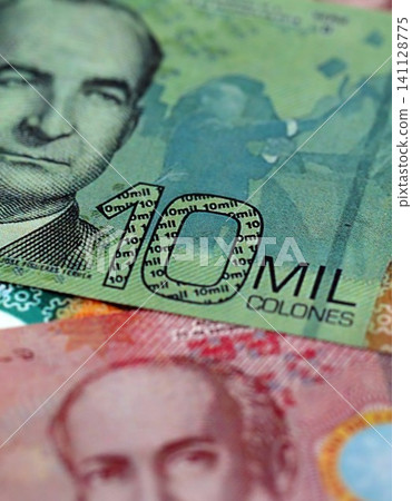 Costa Rican new colon money bills pile on table. Costa Rica banknotes of CRC currency close up 141128775