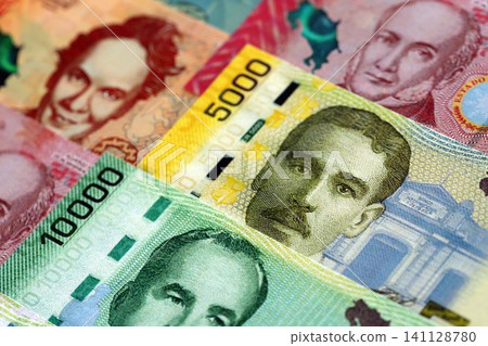 Costa Rican colon money bills pile on table. Costa Rica banknotes of CRC currency close up Costa Rican colon money bills pile on table. Costa Rica banknotes of CRC currency close up 141128780