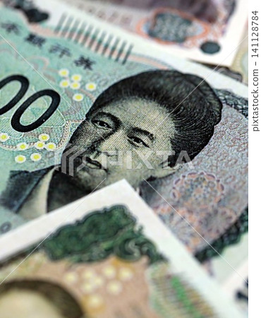 Japanese yen money bills pile on table. Japan banknotes of JPY currency close up Japanese yen money bills pile on table. Japan banknotes of JPY currency close up 141128784