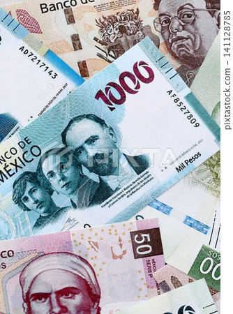 Mexican peso money bills pile on table. Mexico banknotes of MXN currency. Concept of business Mexican peso money bills pile on table. Mexico banknotes of MXN currency. Concept of business 141128785