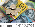 Australian dollar money bills and cent coins pile. Australia coins on banknotes of AUD currency 141128794