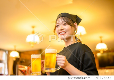 A smiling woman serving beer A smiling woman serving beer 141128838