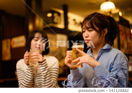 Woman drinking beer Woman drinking beer 141128882