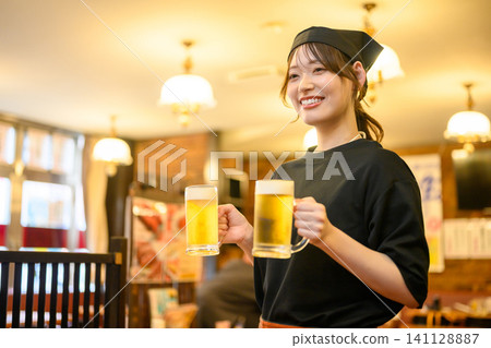A smiling store clerk holding a beer 141128887