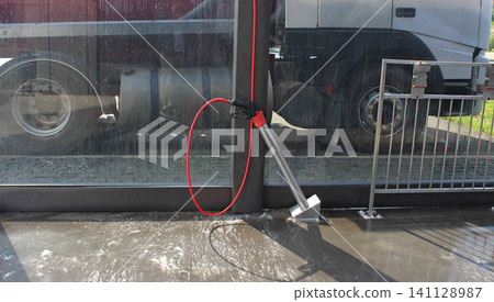 Glass partition at self service car wash station for washing trucks Glass partition at self service car wash station for washing trucks 141128987