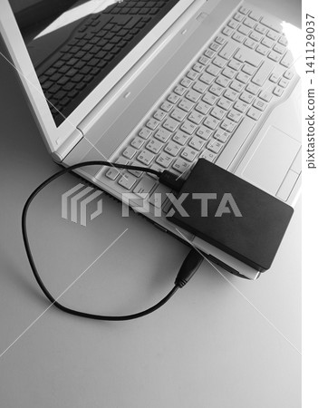 A laptop with a bilingual keyboard and a Portable Disc Drive connected via USB A laptop with a bilingual keyboard and a Portable Disc Drive connected via USB 141129037