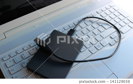 Black External Disc On A White Buttons Of Bilingual Keyboard With Cyrillic And Latin Characters Black External Disc On A White Buttons Of Bilingual Keyboard With Cyrillic And Latin Characters 141129038