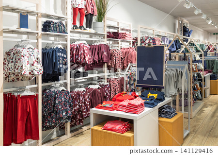 Childrens and teen apparel display on retail store shelving Childrens and teen apparel display on retail store shelving 141129416