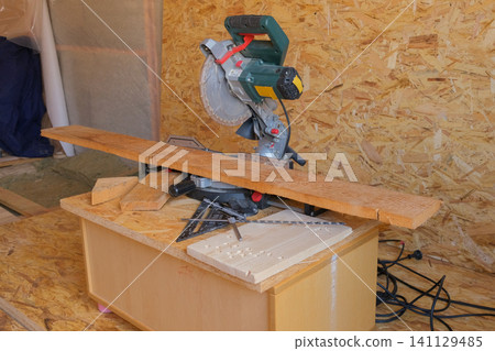 Retro vintage workshop. Circular Saw Industrial workplace manual vocation skills concept. Woodworking. Desktop for pine board cuts. Carpenter tools background. Old joinery table with furniture details Retro vintage workshop. Circular Saw Industrial workplace manual vocation skills concept. Woodworking. Desktop for pine board cuts. Carpenter tools background. Old joinery table with furniture details 141129485