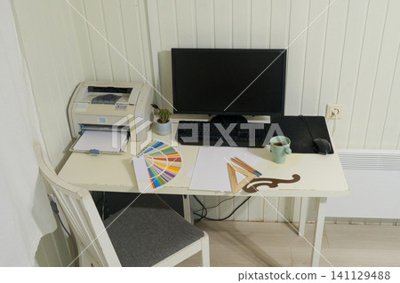 Remote workplace. Modern creative designer home workspace. Laptop, coffee cup, and color guide palette on desk. Remote work. Perfect for business, study, learning or productivity. Home Office Setup. Remote workplace. Modern creative designer home workspace. Laptop, coffee cup, and color guide palette on desk. Remote work. Perfect for business, study, learning or productivity. Home Office Setup. 141129488