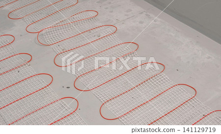 Electric Heating Mat Installing in the Tile Adhesive. Underfloor Dual Core Fiberglass Mesh Mat. Warm Floor Heating System. Warming. Worker Applying Concrete Mortar for Warm Floor. Renovation work. 4K 141129719
