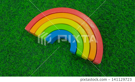 Eco friendly wooden rainbow toy for early childhood development. Concept of a children's store of educational toys. Wooden Stacking Rainbow Toy for creativity. Children's waldorf or montessori school. Eco friendly wooden rainbow toy for early childhood development. Concept of a children's store of educational toys. Wooden Stacking Rainbow Toy for creativity. Children's waldorf or montessori school. 141129723