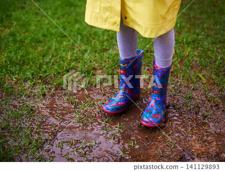 Soil, feet and boots of kid playing in rain for forest, adventure or fun explore games in nature closeup. Earth, mud and shoes of child in woods for walking, camping or travel, holiday or vacation Soil, feet and boots of kid playing in rain for forest, adventure or fun explore games in nature closeup. Earth, mud and shoes of child in woods for walking, camping or travel, holiday or vacation 141129893