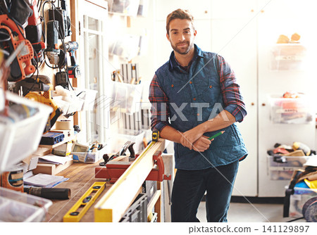 Carpenter, woodwork and portrait of man in workshop for home development, diy tools and building renovation. Smiling, male employee and contractor for maintenance, equipment and repair work in garage Carpenter, woodwork and portrait of man in workshop for home development, diy tools and building renovation. Smiling, male employee and contractor for maintenance, equipment and repair work in garage 141129897