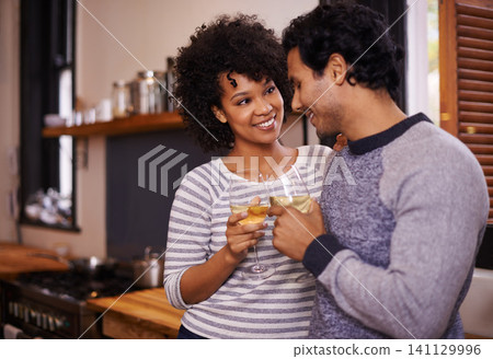 Couple, wine and cheers for love, romance and passion for romantic, dating and relationship together. Boyfriend, girlfriend and young people for interracial pair for happy and drink in kitchen 141129996