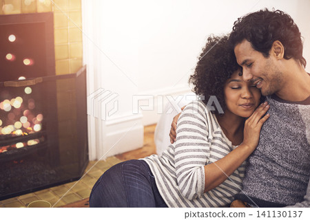 Couple, fireplace and love in embrace, home and peace or calm and proud of marriage or commitment. People, romance and hugging on floor in living room on weekend, support and trust in relationship Couple, fireplace and love in embrace, home and peace or calm and proud of marriage or commitment. People, romance and hugging on floor in living room on weekend, support and trust in relationship 141130137