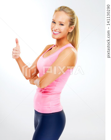 Studio, portrait and woman with thumbs up for exercise, personal trainer and support or vote for fitness. Adult, female person and girl with smile for workout, happiness and thank you for training Studio, portrait and woman with thumbs up for exercise, personal trainer and support or vote for fitness. Adult, female person and girl with smile for workout, happiness and thank you for training 141130290