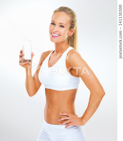 Portrait, happy woman and glass of milk for fitness in studio background with nutrition, vitamins and calcium. Organic, healthy and wellness for diet with dairy, protein and muscle to support bone Portrait, happy woman and glass of milk for fitness in studio background with nutrition, vitamins and calcium. Organic, healthy and wellness for diet with dairy, protein and muscle to support bone 141130300