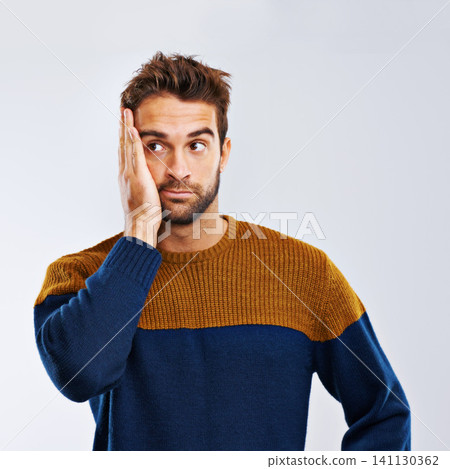 Man, thinking and worry with stress, depression or anxiety in secret on a gray studio background. Young guy, model or upset male person in mistake, disappointment or mental health on mockup space Man, thinking and worry with stress, depression or anxiety in secret on a gray studio background. Young guy, model or upset male person in mistake, disappointment or mental health on mockup space 141130362