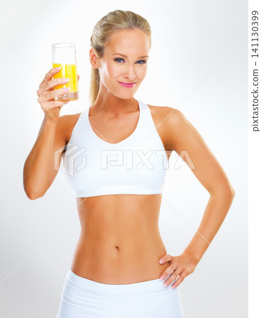 Studio, happy and portrait of woman with orange juice for healthy diet, nutrition and vitamin c. Glass, underwear and person with citrus beverage for detox, weightloss or wellness on white background Studio, happy and portrait of woman with orange juice for healthy diet, nutrition and vitamin c. Glass, underwear and person with citrus beverage for detox, weightloss or wellness on white background 141130399