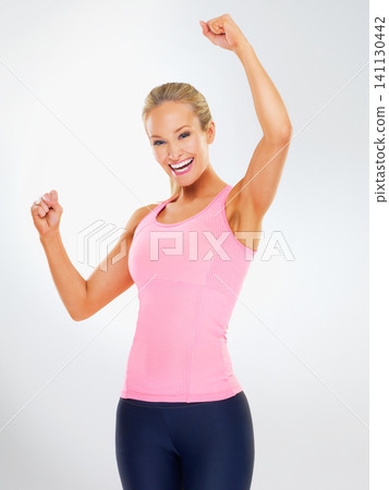 Fitness, portrait and woman with sportswear, excited or winning with healthy body care in studio. Exercise, wellness and happy girl on white background for workout success, commitment and celebration Fitness, portrait and woman with sportswear, excited or winning with healthy body care in studio. Exercise, wellness and happy girl on white background for workout success, commitment and celebration 141130442
