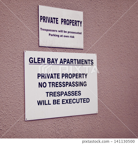 Trespassing, warning and sign on apartment of property for caution, notification and information. Public signage, symbol and private building with board, poster and mistake for attention or safety Trespassing, warning and sign on apartment of property for caution, notification and information. Public signage, symbol and private building with board, poster and mistake for attention or safety 141130500