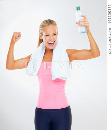 Portrait, woman and flexing with water in studio for fitness, workout and training in white background. Athlete, female person and smile with liquid for hydration, healthy and wellness for self care Portrait, woman and flexing with water in studio for fitness, workout and training in white background. Athlete, female person and smile with liquid for hydration, healthy and wellness for self care 141130583