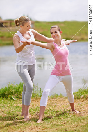 Women, yoga class and help with exercise outdoor for health, wellness and healing with coach. Fitness, pilates and stretching muscle for workout in park or garden, personal trainer and balance Women, yoga class and help with exercise outdoor for health, wellness and healing with coach. Fitness, pilates and stretching muscle for workout in park or garden, personal trainer and balance 141130695