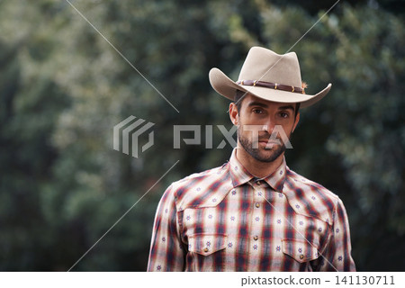 Man, portrait and outdoor cowboy fashion, western culture and countryside ranch in Texas. Male person, hat and flannel shirt for farmer aesthetic, nature and plaid style by trees or outside bush Man, portrait and outdoor cowboy fashion, western culture and countryside ranch in Texas. Male person, hat and flannel shirt for farmer aesthetic, nature and plaid style by trees or outside bush 141130711
