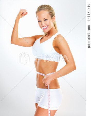 Celebration, measuring tape and woman in portrait for fitness in studio with smile, health and wellness progress with results. Girl, training and workout or exercise for self care on white background Celebration, measuring tape and woman in portrait for fitness in studio with smile, health and wellness progress with results. Girl, training and workout or exercise for self care on white background 141130719