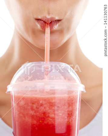 Lips, straw and drinking a smoothie in studio, nutrition and wellness with juice on white background. Person, closeup and milkshake for weight loss or detox, minerals and vegetarian fiber or organic Lips, straw and drinking a smoothie in studio, nutrition and wellness with juice on white background. Person, closeup and milkshake for weight loss or detox, minerals and vegetarian fiber or organic 141130763