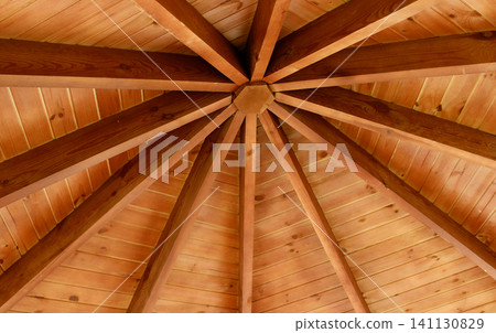 Geometric structure of supporting beams inside a wooden cottage with a round roof Geometric structure of supporting beams inside a wooden cottage with a round roof 141130829