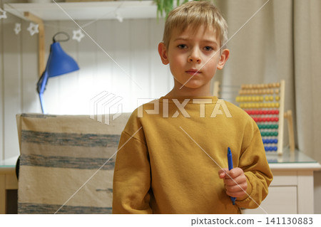 Preschooler engaged with colorful abacus in peaceful room. Boy carefully counts with abacus in comfortable room environment. Young Preschool kid practicing counting concentrates on number practice Preschooler engaged with colorful abacus in peaceful room. Boy carefully counts with abacus in comfortable room environment. Young Preschool kid practicing counting concentrates on number practice 141130883