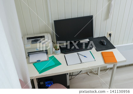 Orderly workspace setup. Organized desk, work from home concept. Remote office station with computer display, keyboard, paperwork. Work place for distance working. Tidy table with monitor and printer Orderly workspace setup. Organized desk, work from home concept. Remote office station with computer display, keyboard, paperwork. Work place for distance working. Tidy table with monitor and printer 141130956