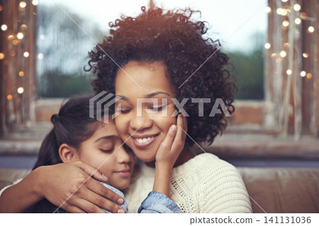 Mother, child and hug on couch in home for weekend relaxing or holiday bonding, love or support. Woman, daughter and embrace connection in apartment living room for vacation care, youth or parenting 141131036